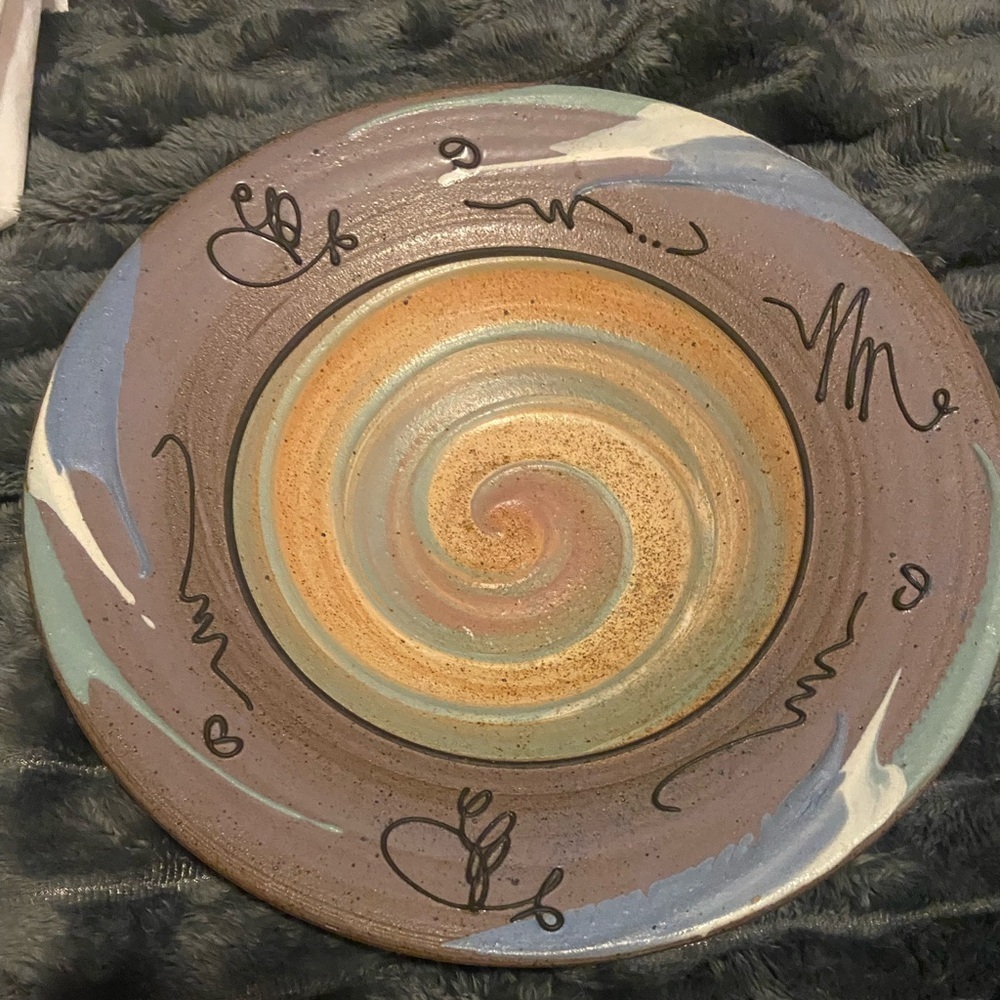 The image shows a hand-thrown, drip-glazed pastel charger from the 1980s.